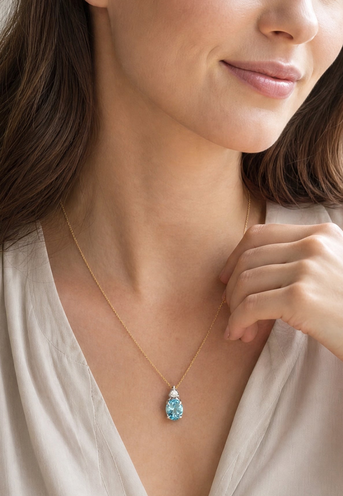 9ct white gold oval aquamarine and diamond pendant with triangular diamond accent.