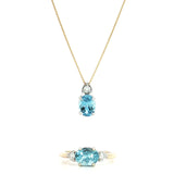 9ct white gold oval aquamarine and diamond pendant with triangular diamond accent.
