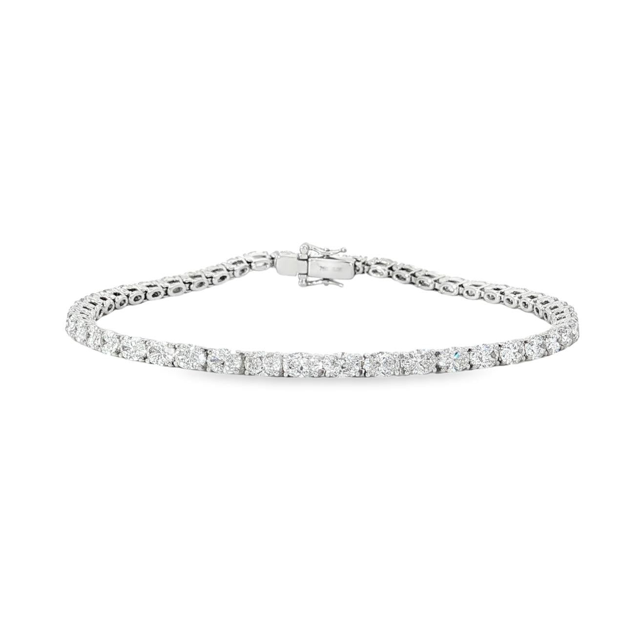 18ct white gold tennis bracelet with oval brilliant cut diamonds in four-claw settings.