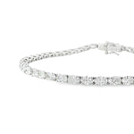 18ct white gold tennis bracelet with oval brilliant cut diamonds in four-claw settings.
