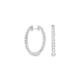 18ct white gold oval diamond huggie earrings with diamonds along the front and inside back.