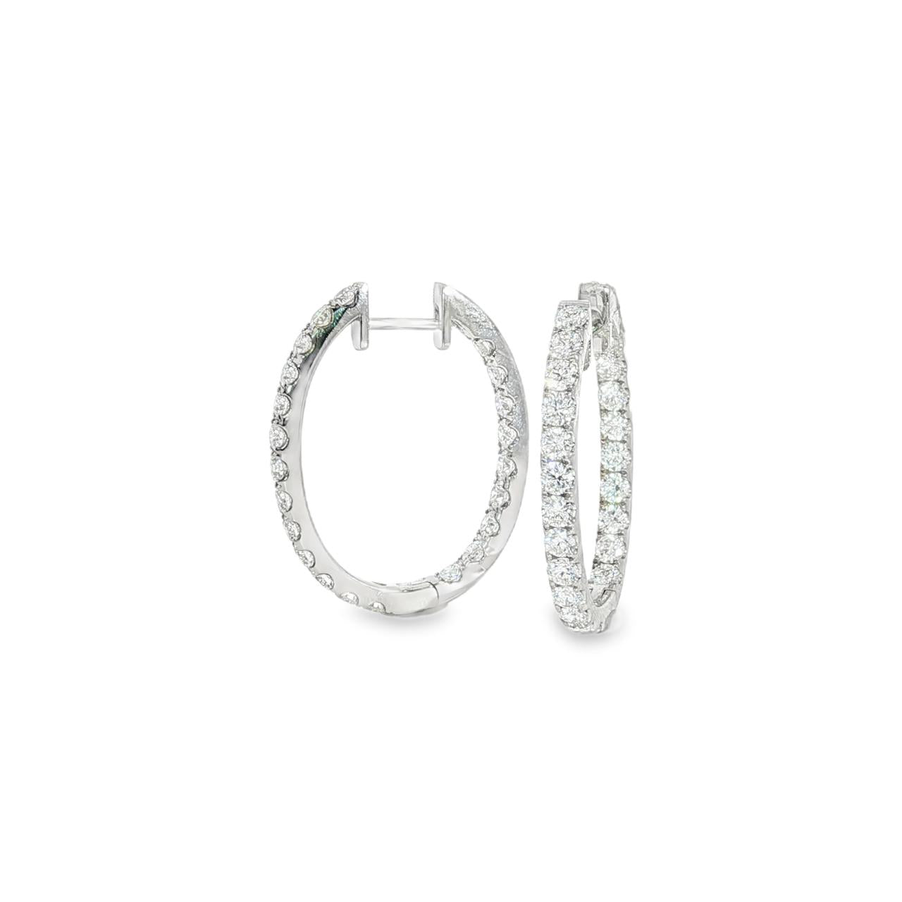 18ct white gold oval diamond huggie earrings with diamonds along the front and inside back.