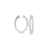 18ct white gold oval diamond huggie earrings with diamonds along the front and inside back.