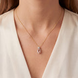 9ct white gold oval morganite and diamond pendant with triangular diamond detail.