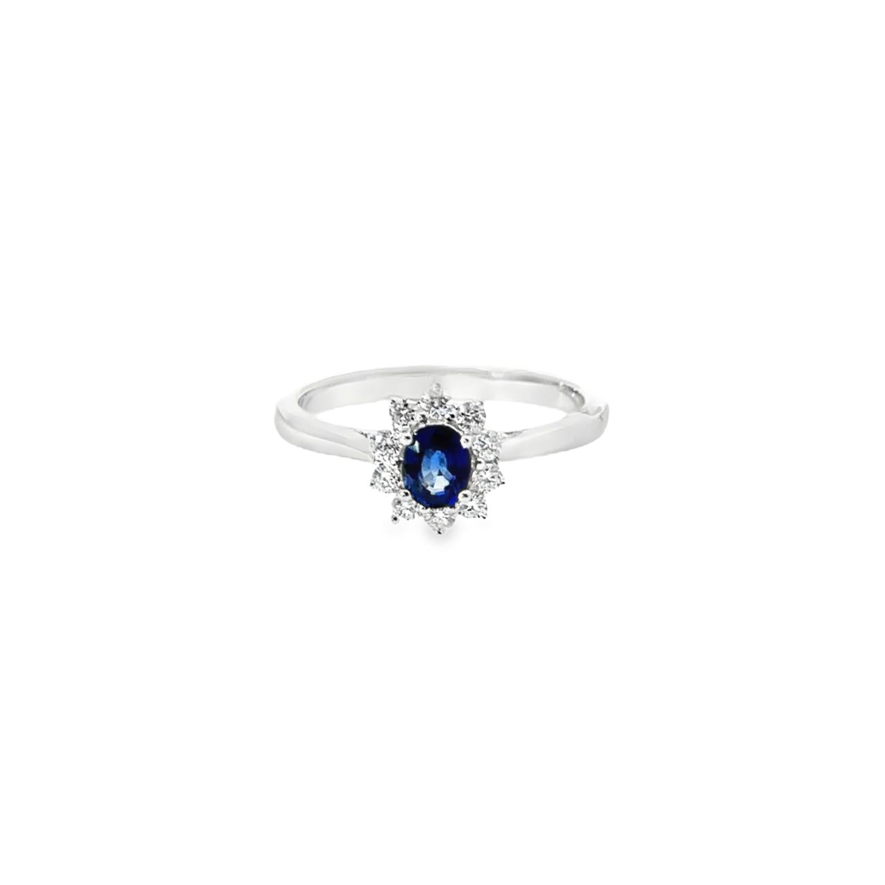 18ct white gold oval sapphire ring with diamond cluster surround.