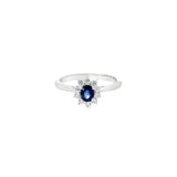 18ct white gold oval sapphire ring with diamond cluster surround.