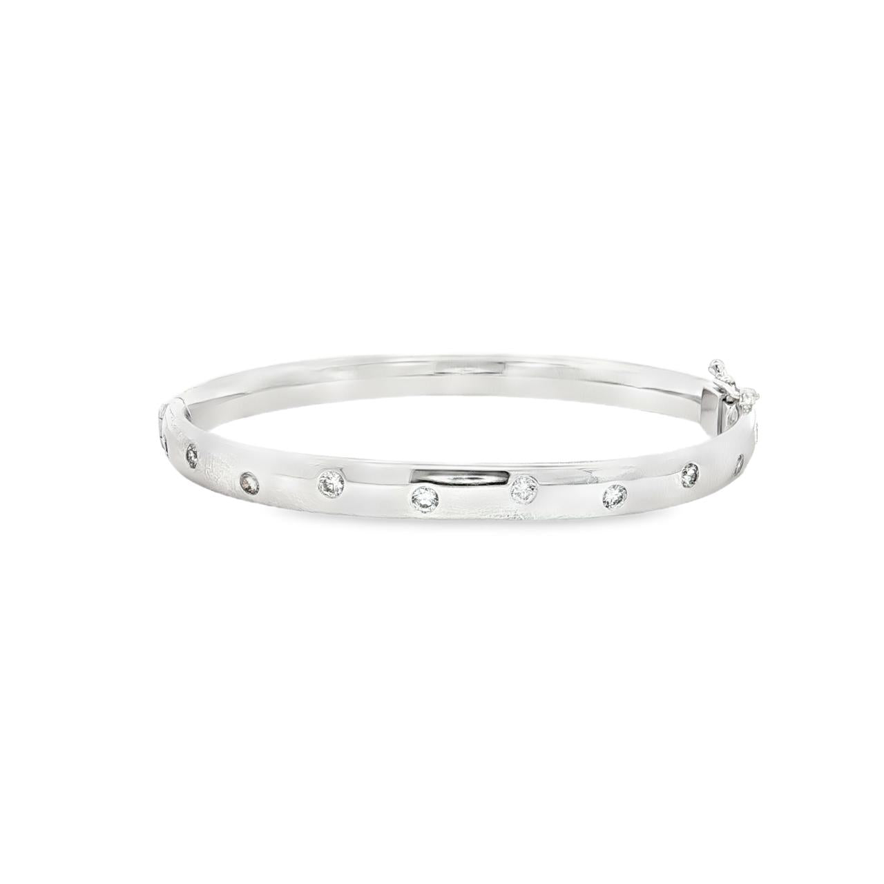18ct white gold scatter-set diamond bangle with rounded oval profile.