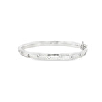 18ct white gold scatter-set diamond bangle with rounded oval profile.