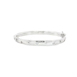 18ct white gold scatter-set diamond bangle with rounded oval profile.
