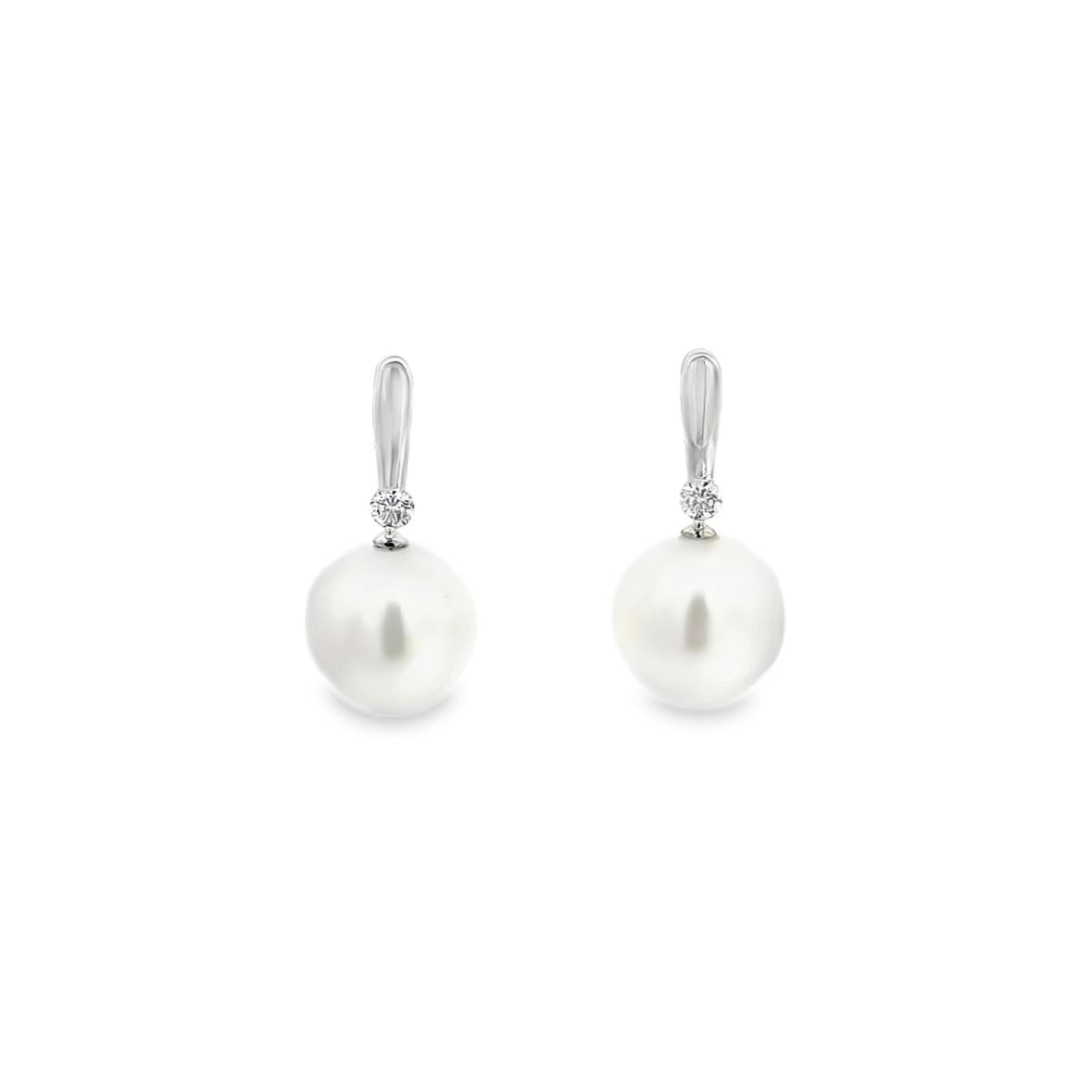 18ct white gold stud earrings with 9mm oval South Sea pearls and claw-set diamonds.