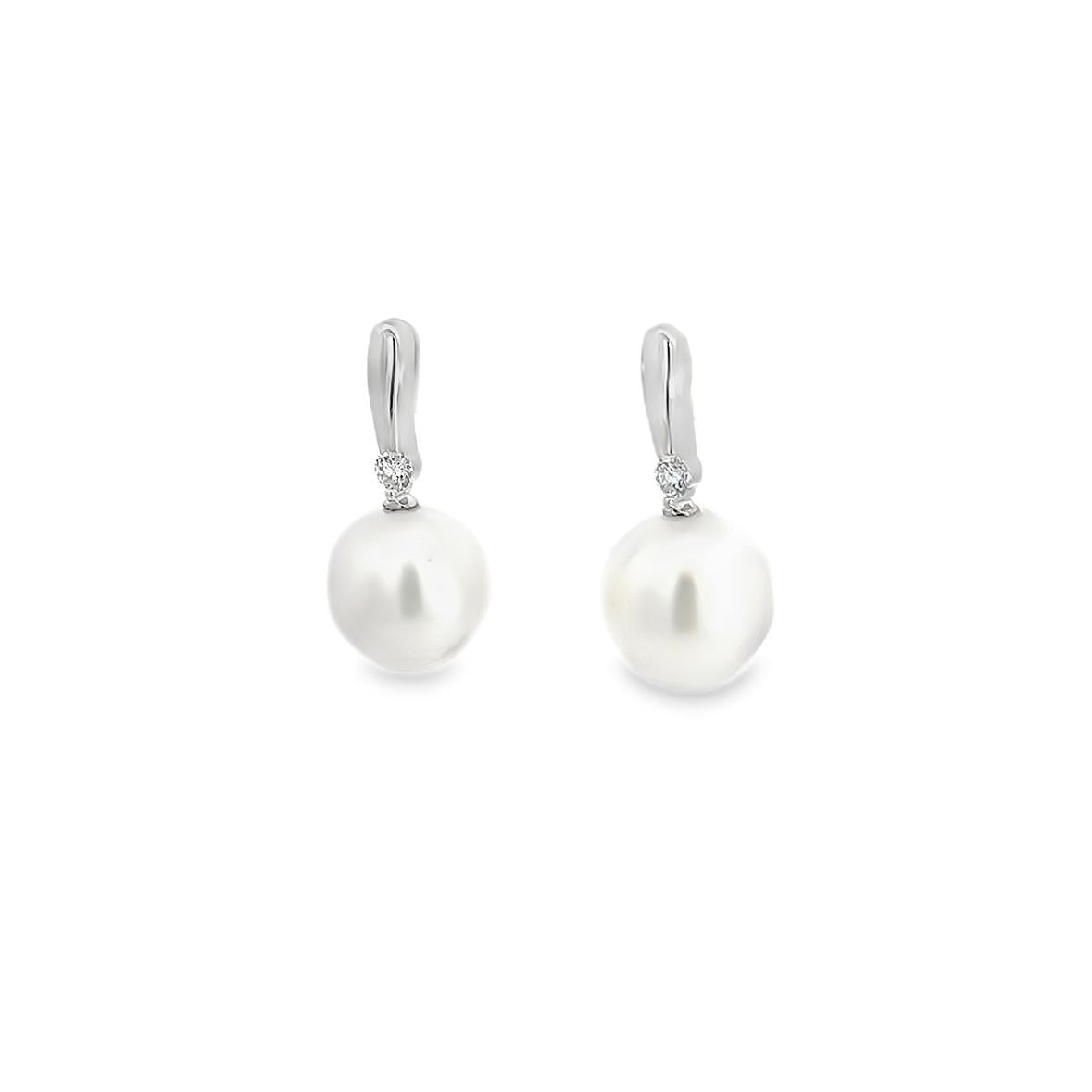 18ct white gold stud earrings with 9mm oval South Sea pearls and claw-set diamonds.