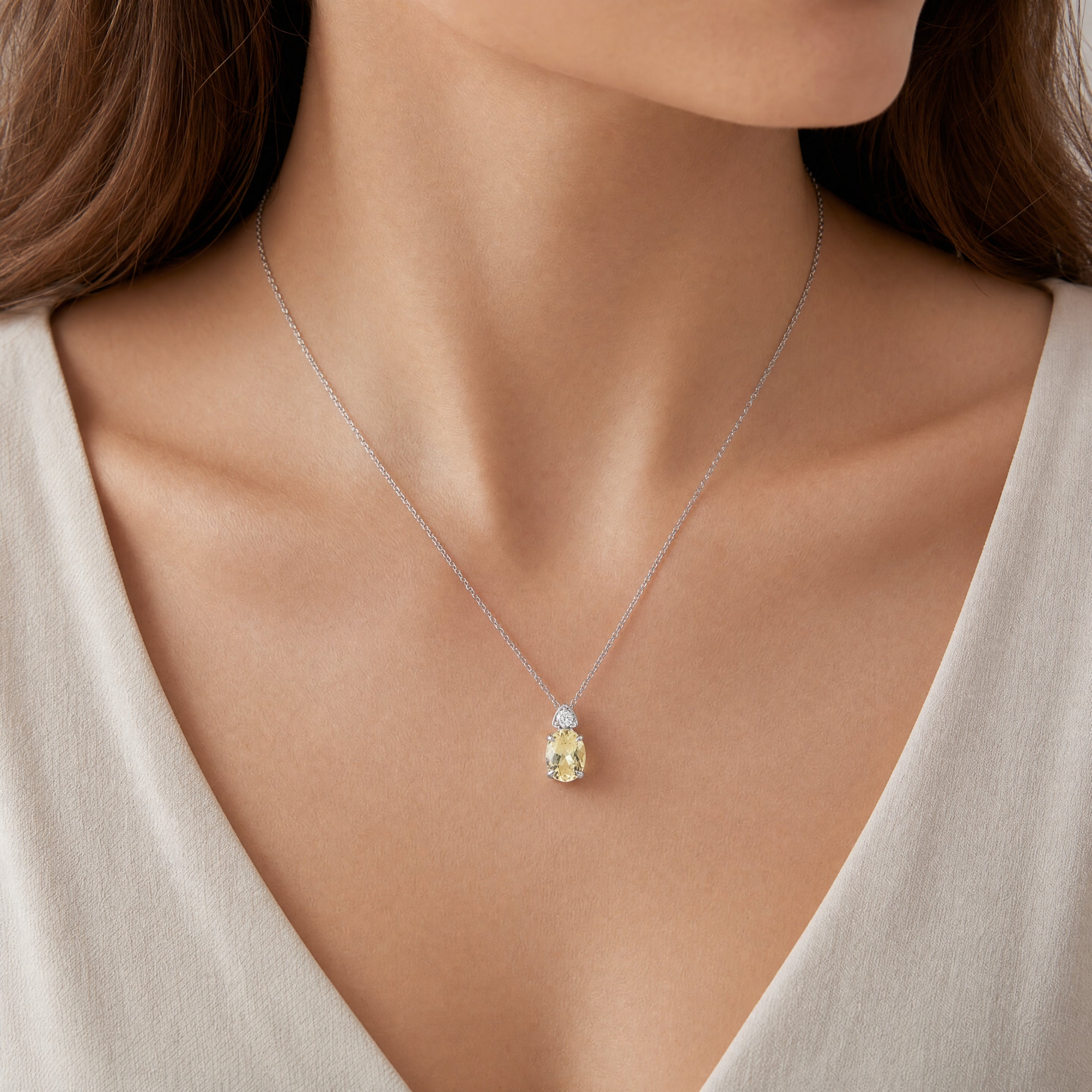 9ct white gold yellow beryl and diamond pastel pendant with oval gemstone and concealed runner.