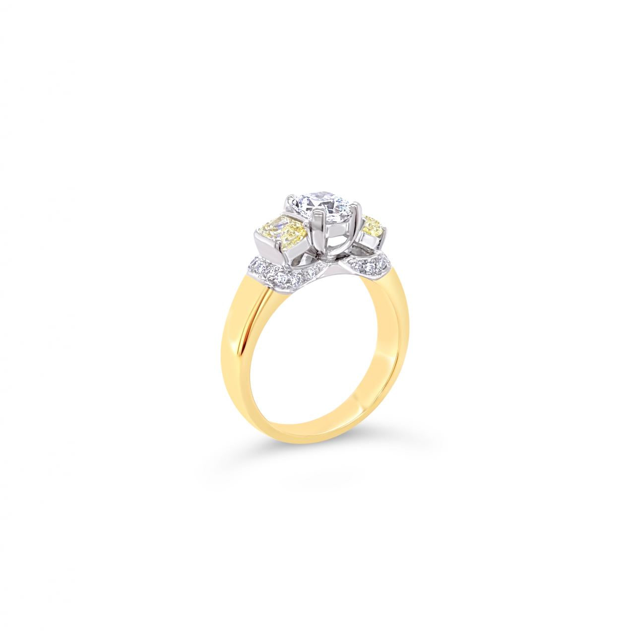 18ct yellow and white gold diamond ring featuring a 0.91ct cushion cut centre diamond with Fancy Yellow side diamonds and round diamond accents.