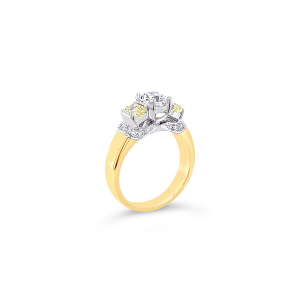 18ct yellow and white gold diamond ring featuring a 0.91ct cushion cut centre diamond with Fancy Yellow side diamonds and round diamond accents.