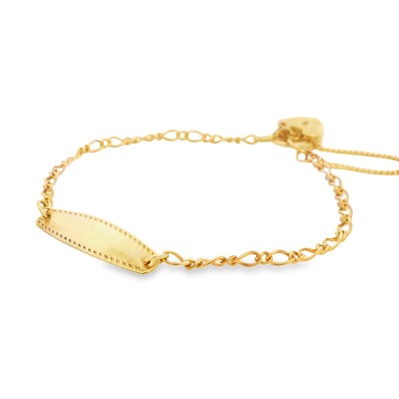 Baby bracelet crafted in yellow gold featuring a Figaro link chain, polished ID bar, and padlock clasp.