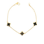 9ct yellow gold trace link bracelet with three black clover motifs.
