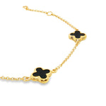 9ct yellow gold trace link bracelet with three black clover motifs.