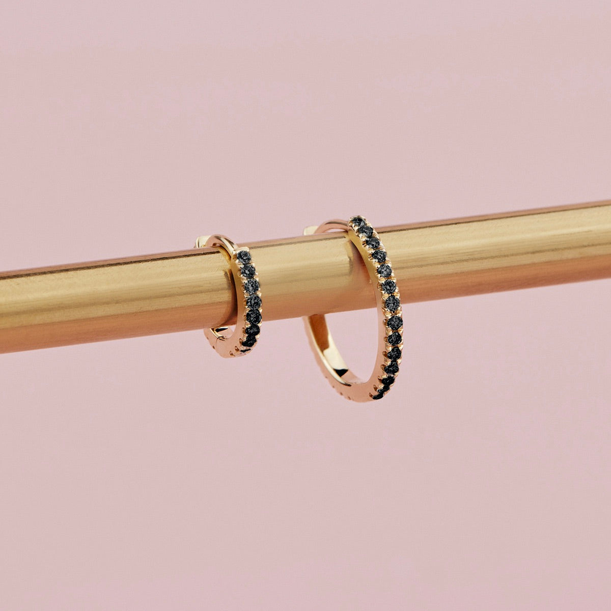 18ct yellow gold black diamond huggie earrings with claw-set stones front and back.