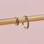 18ct yellow gold black diamond huggie earrings with claw-set stones front and back.