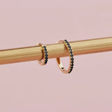 18ct yellow gold black diamond huggie earrings with claw-set stones front and back.