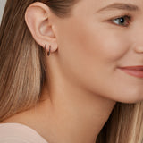 18ct yellow gold black diamond huggie earrings with claw-set stones front and back.