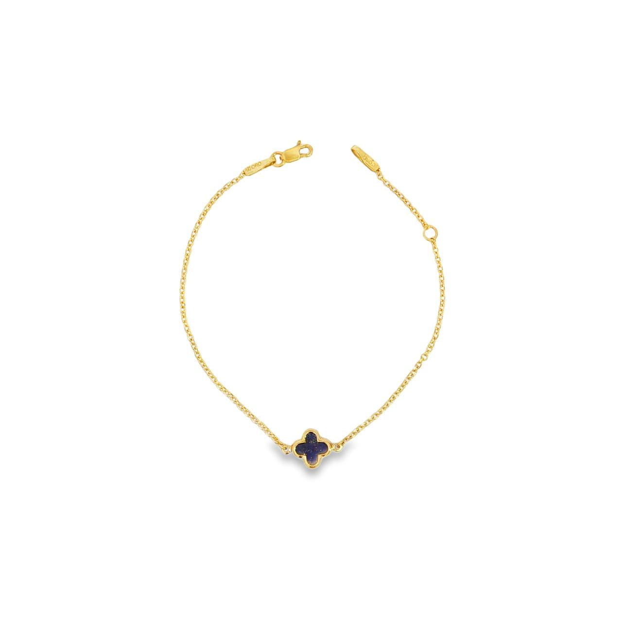 9ct yellow gold trace link bracelet with small blue clover centre.