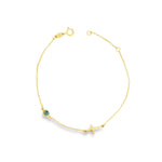 9ct yellow gold trace link bracelet with horizontal cross and Evil Eye charm.