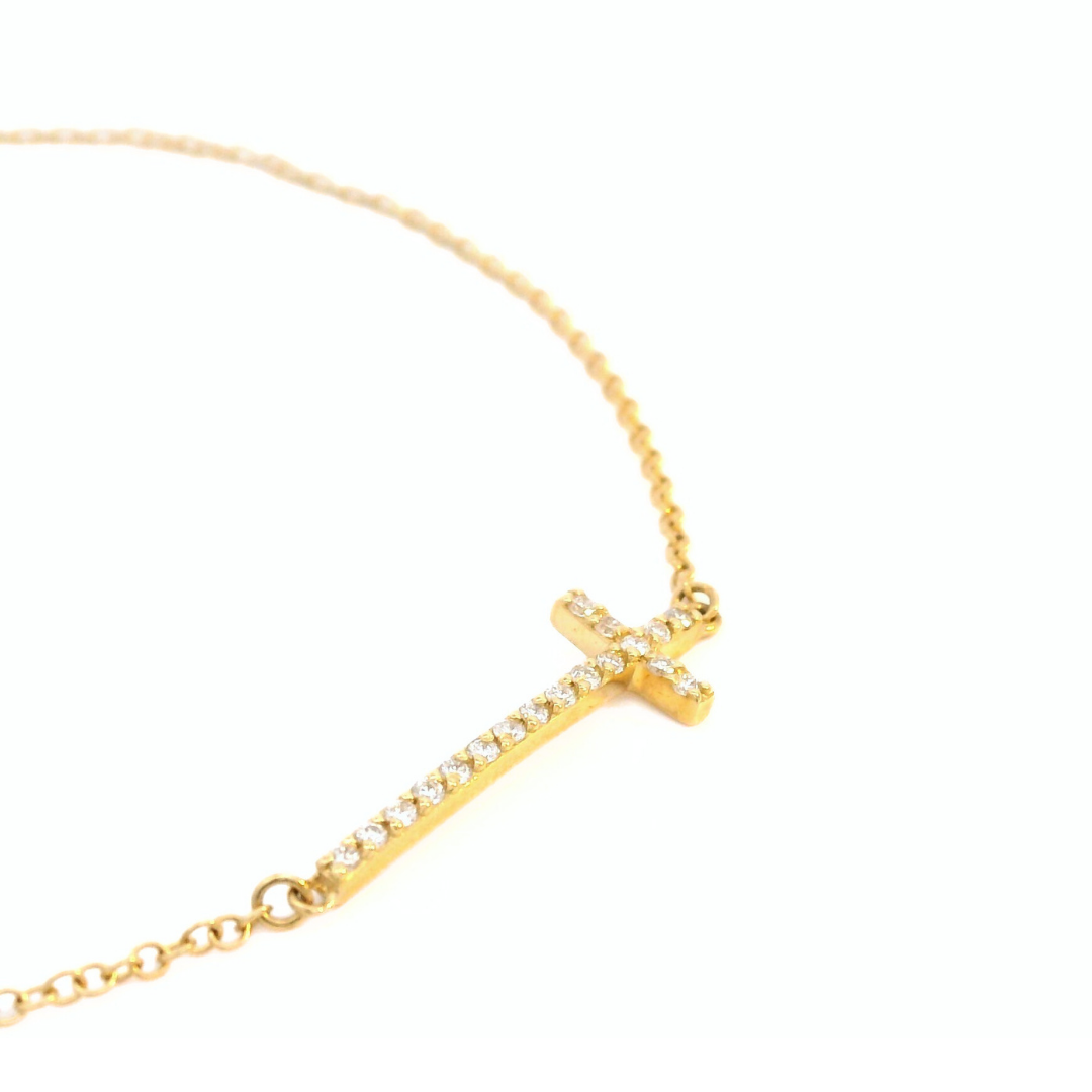 18ct yellow gold fine trace link bracelet featuring a horizontal diamond-set cross with 18 round brilliant cut diamonds and parrot clasp.