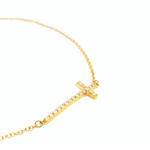 18ct yellow gold fine trace link bracelet featuring a horizontal diamond-set cross with 18 round brilliant cut diamonds and parrot clasp.