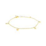 18ct yellow gold fine trace link bracelet with five pear-shaped diamond drops spaced along the length, finished with a parrot clasp.