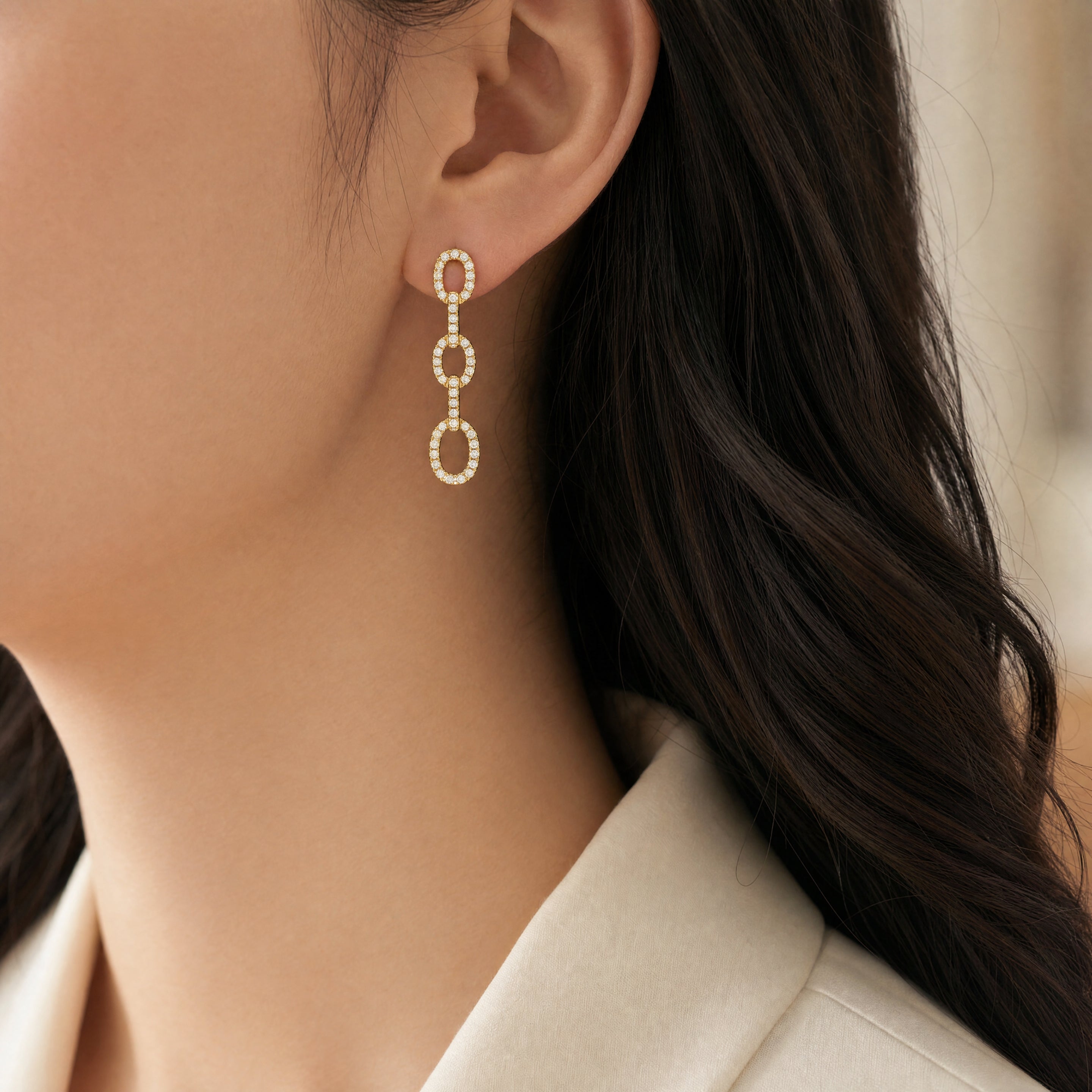 18ct yellow gold triple oval diamond drop earrings with claw-set links.