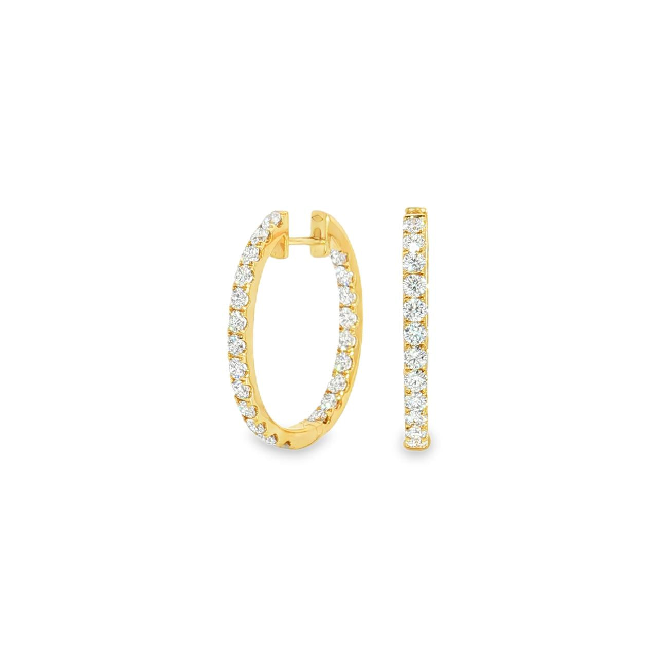 18ct yellow gold oval diamond huggie earrings with diamonds along the front and inside back.
