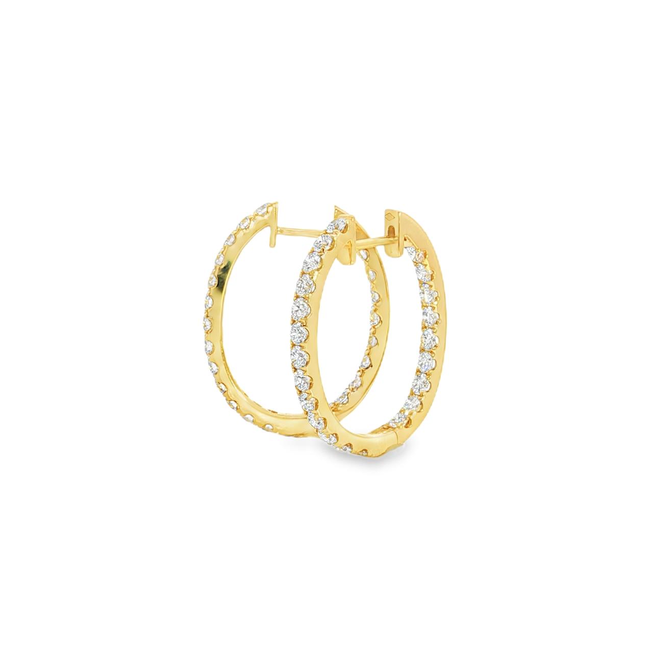 18ct yellow gold oval diamond huggie earrings with diamonds along the front and inside back.