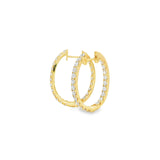 18ct yellow gold oval diamond huggie earrings with diamonds along the front and inside back.