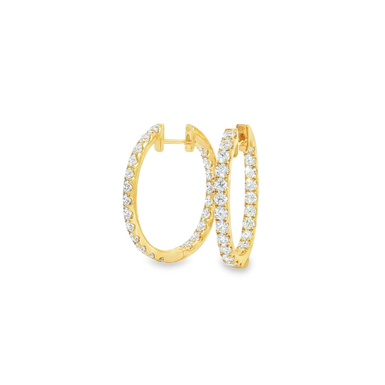 18ct yellow gold oval diamond huggie earrings with diamonds along the front and inside back.