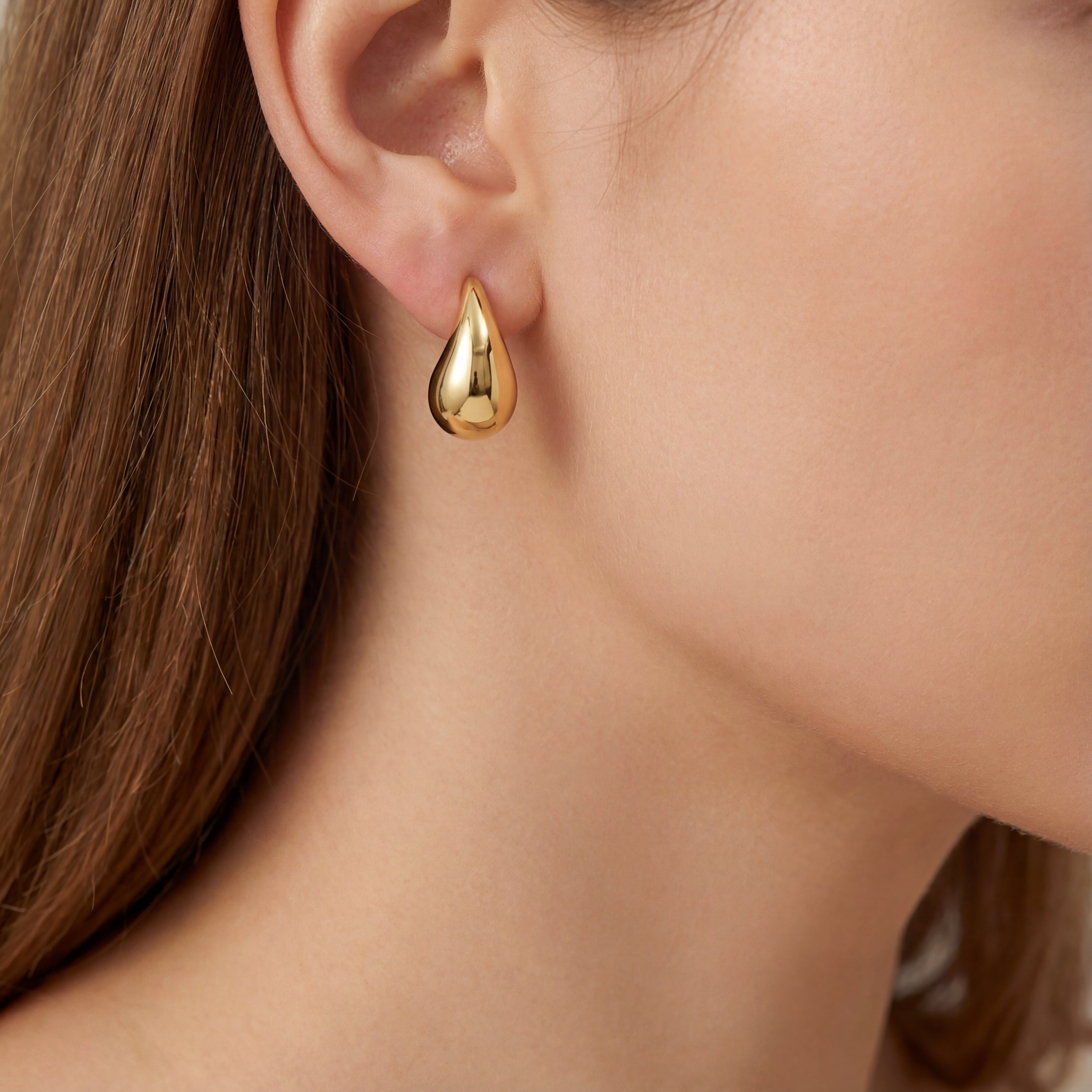 9ct yellow gold puffed pear-shaped stud earrings with polished finish.