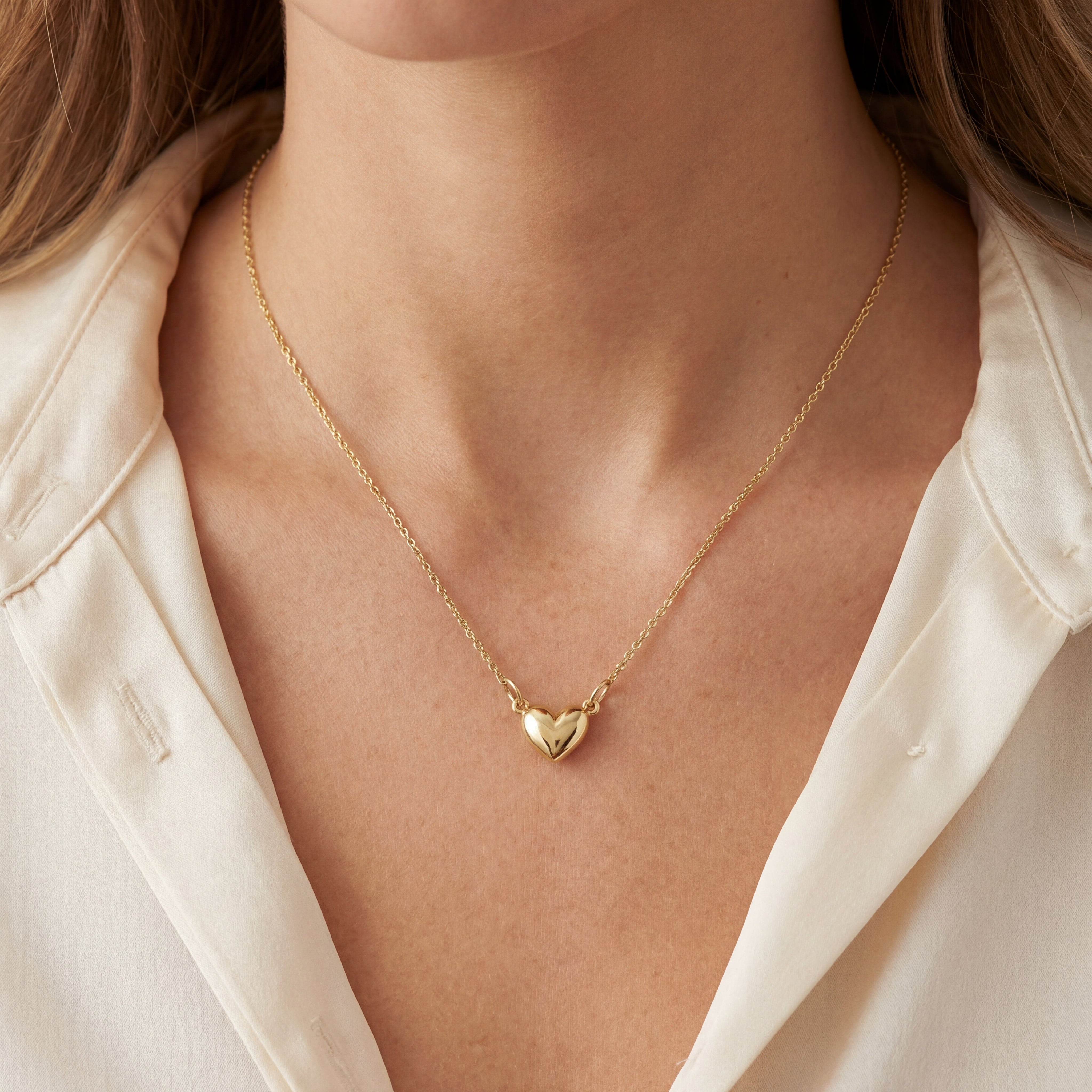 9ct yellow gold necklet with small rounded heart pendant on trace link chain.