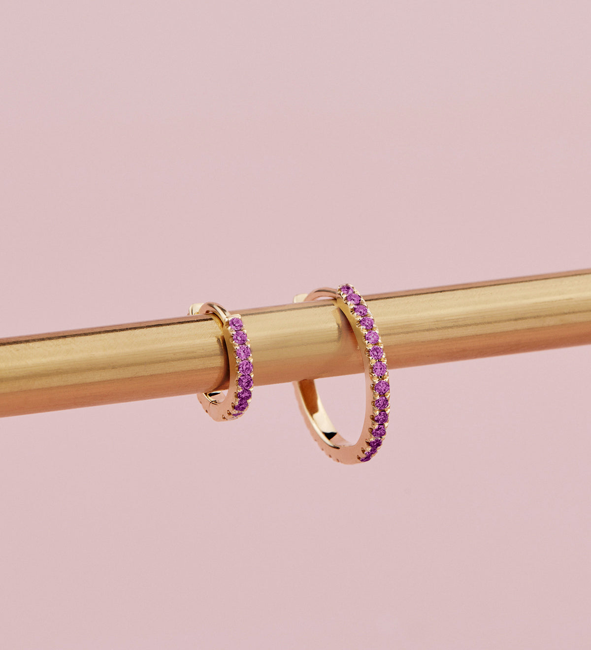 18ct yellow gold ruby huggie earrings with claw-set rubies front and back.