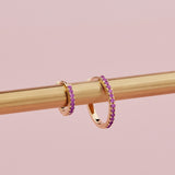 18ct yellow gold ruby huggie earrings with claw-set rubies front and back.