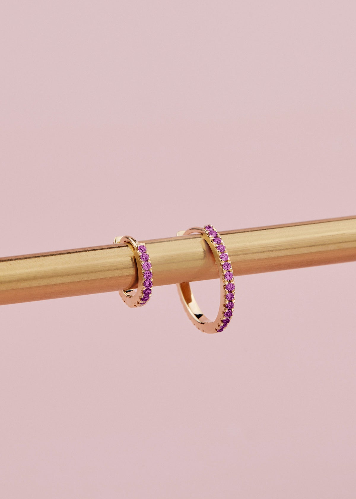 18ct yellow gold ruby huggie earrings with claw-set rubies front and back.