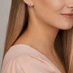 18ct yellow gold ruby huggie earrings with claw-set rubies front and back.