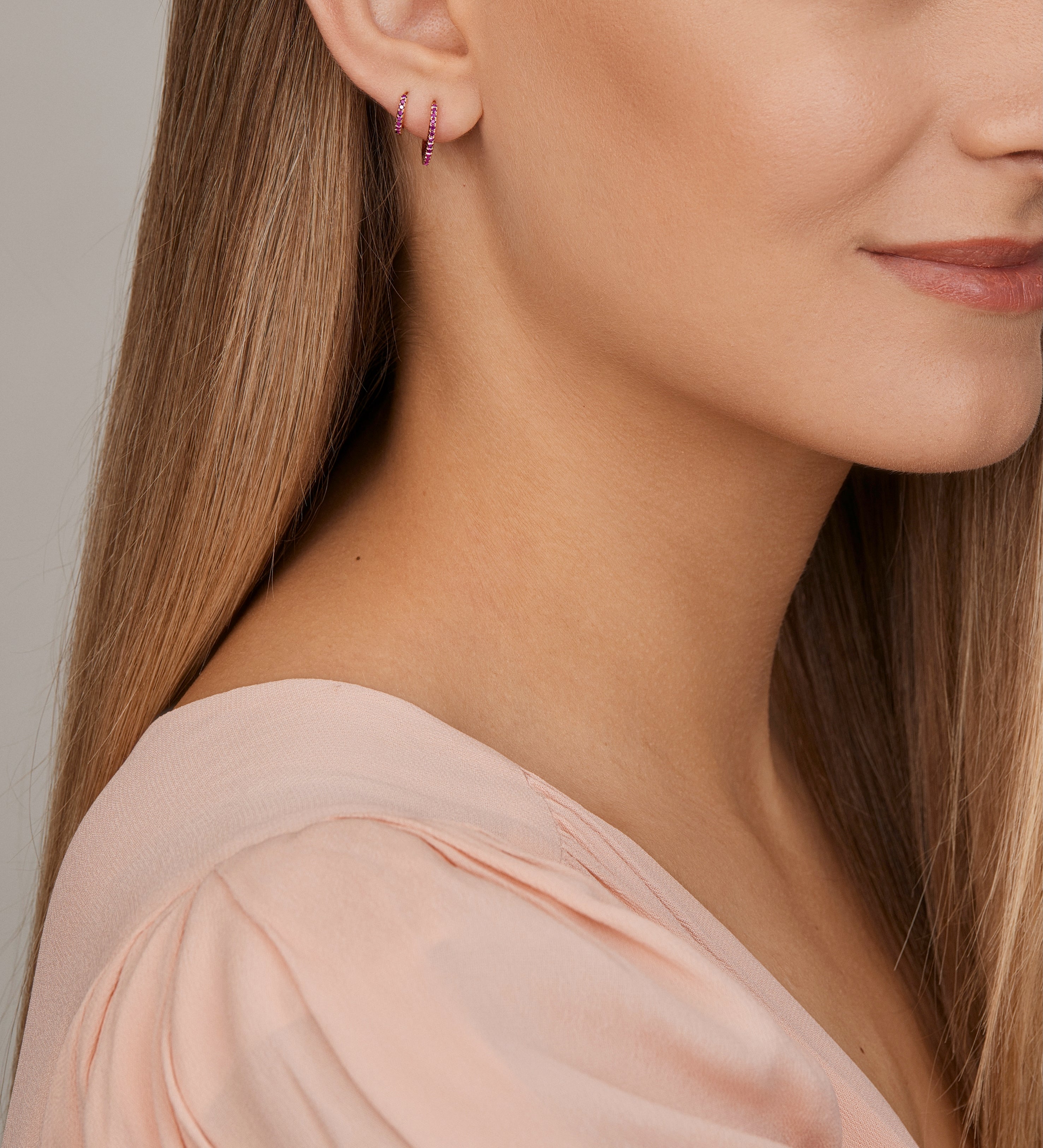 18ct yellow gold ruby huggie earrings with claw-set rubies front and back.