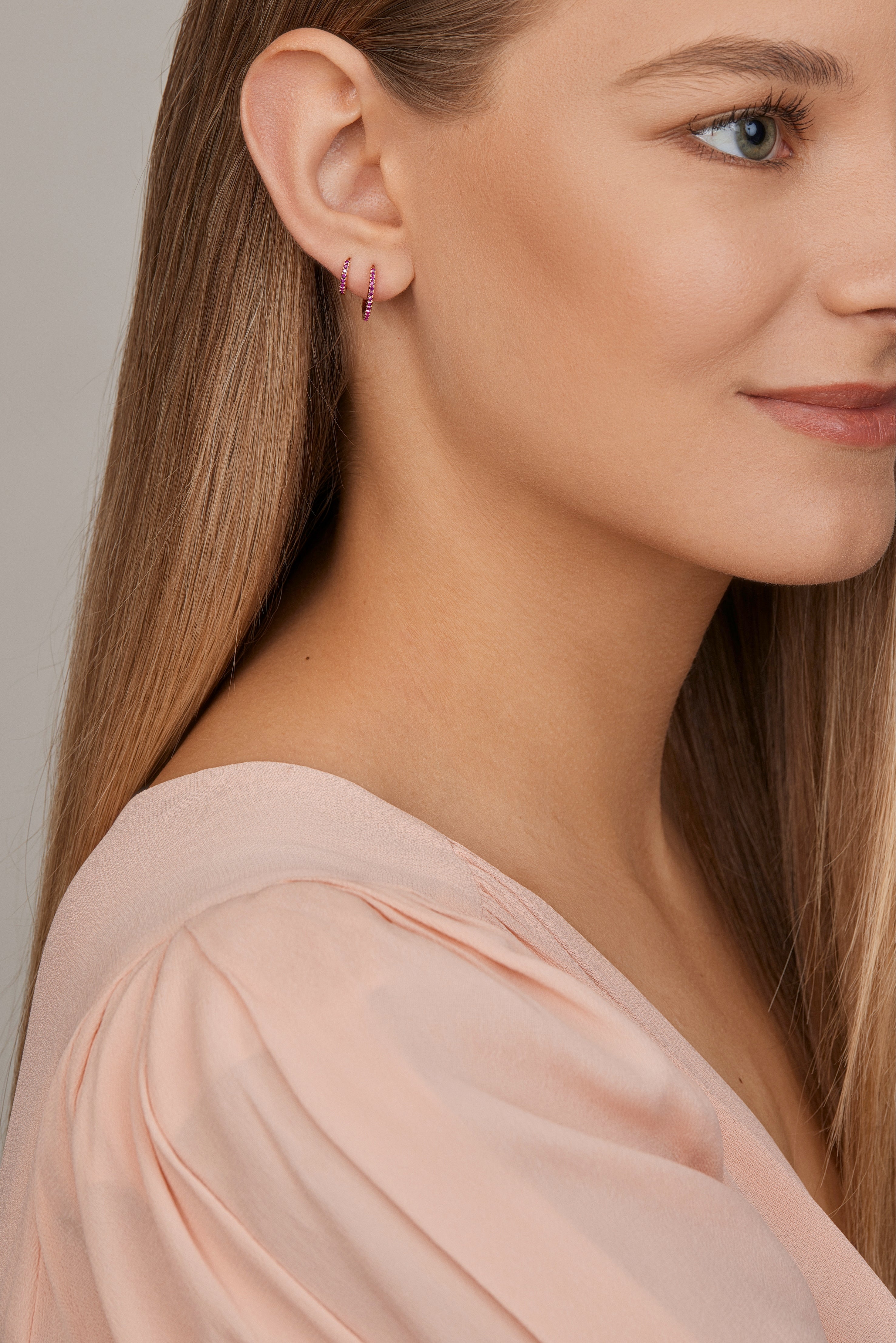 18ct yellow gold ruby huggie earrings with claw-set rubies front and back.