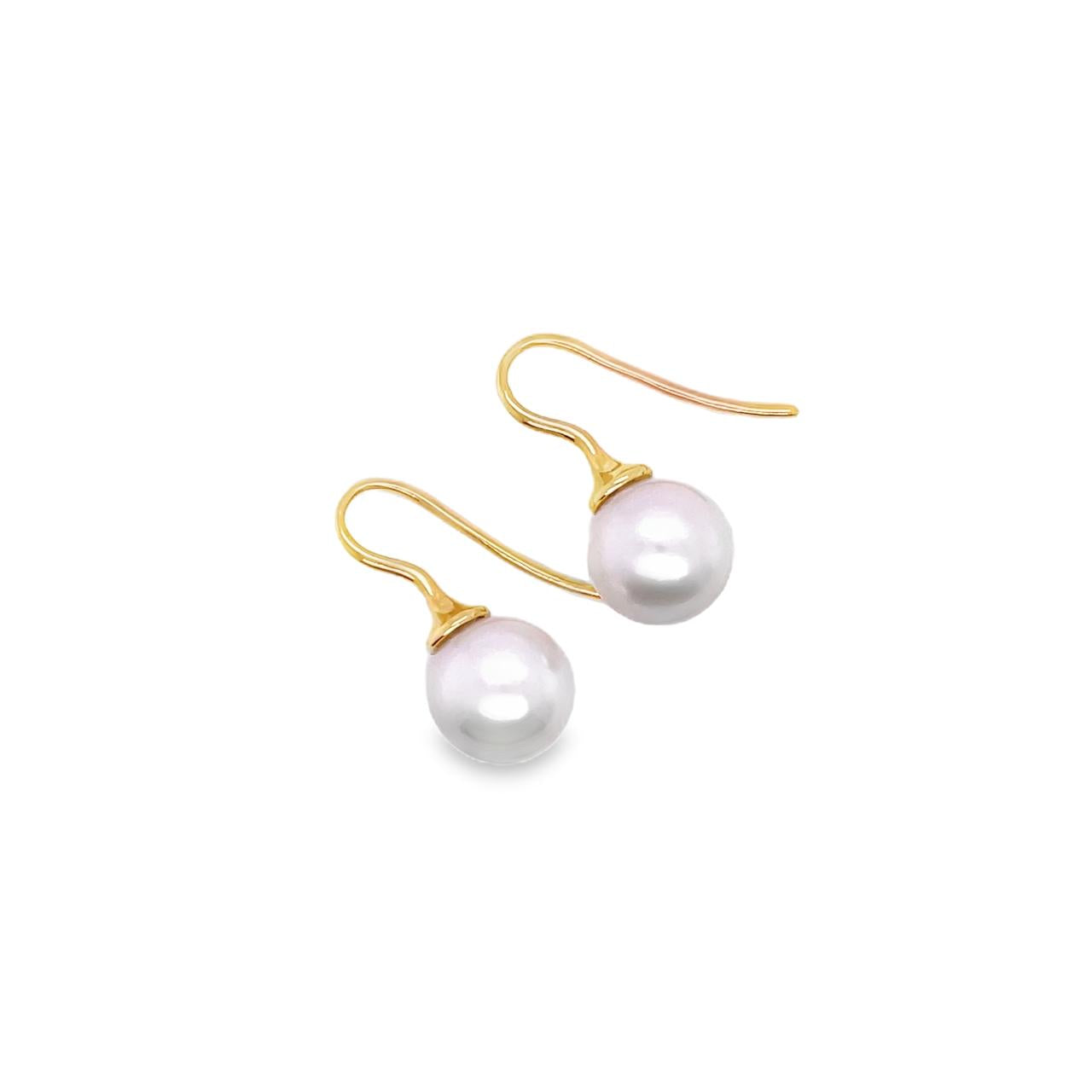 18ct yellow gold hook earrings with tapered caps and 10mm South Sea pearls.