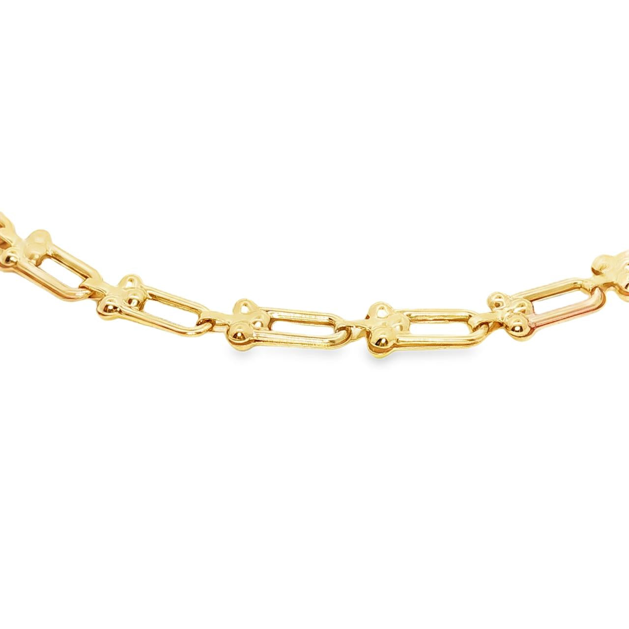 9ct yellow gold bracelet with U-shaped links and cluster bead detailing.