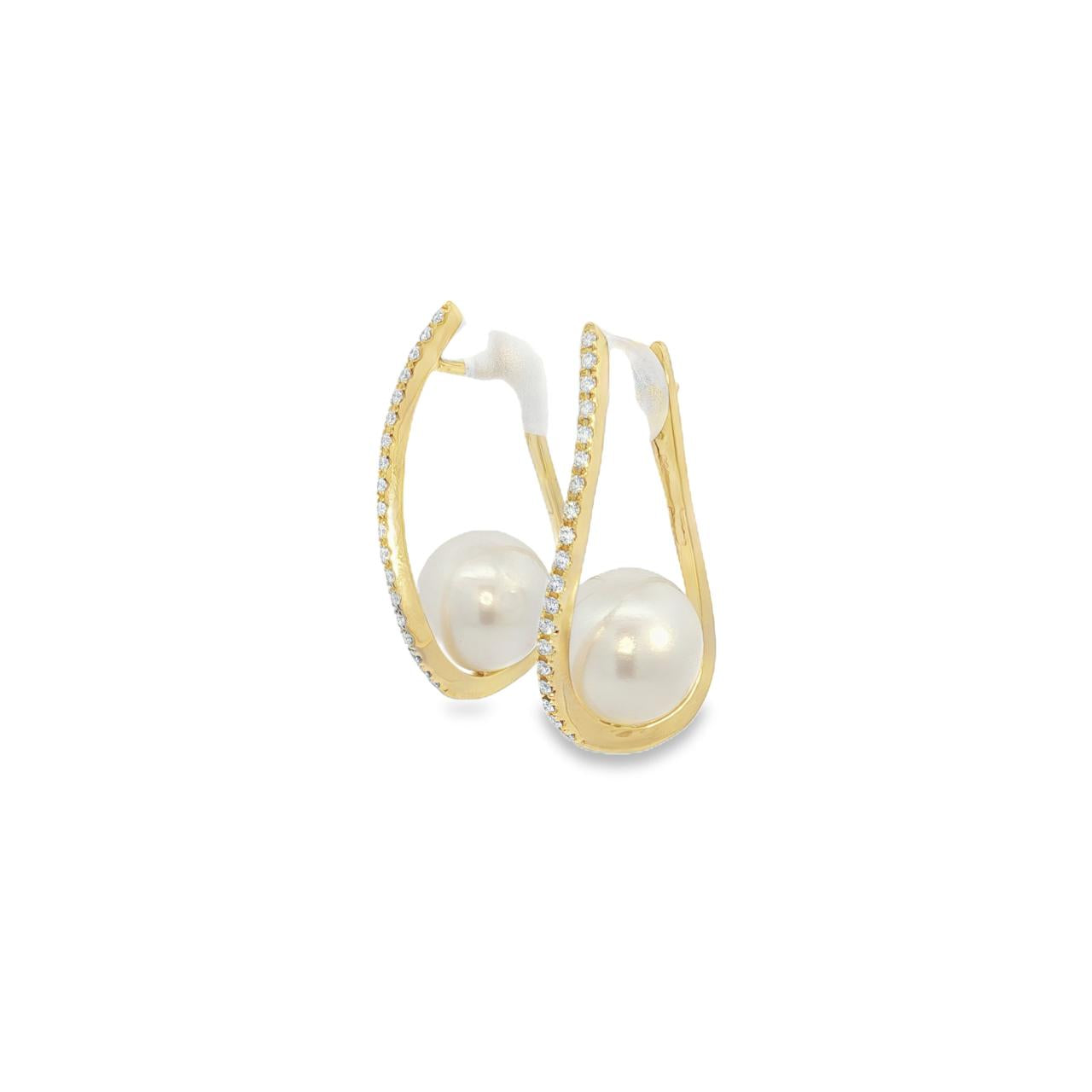18ct yellow gold wave huggie earrings with 10mm South Sea pearls and row-set diamonds.
