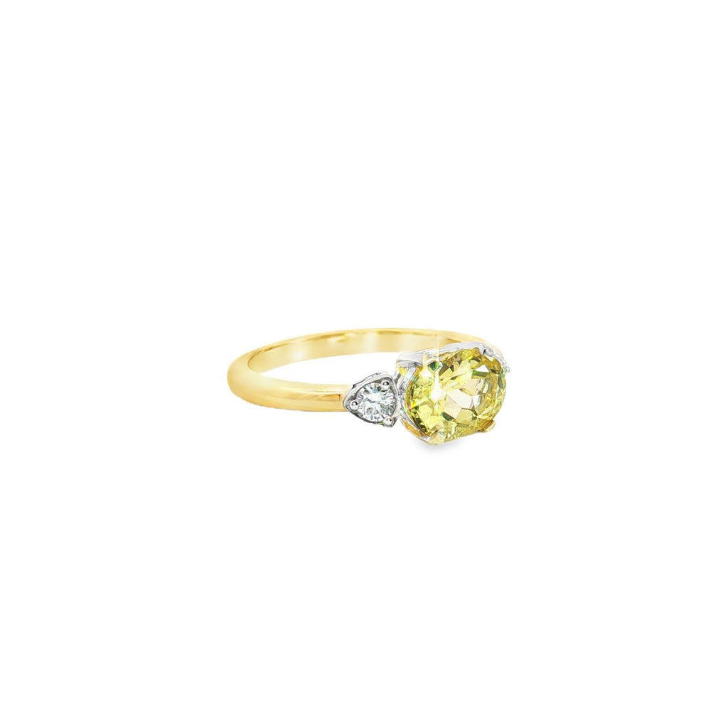 Yellow and white gold ring with horizontal oval yellow beryl and diamond side accents.