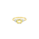 Yellow and white gold ring with horizontal oval yellow beryl and diamond side accents.