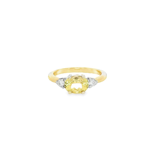 Yellow and white gold ring with horizontal oval yellow beryl and diamond side accents.