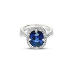 Platinum ring featuring a 4.58ct unheated Ceylon sapphire surrounded by round brilliant cut diamonds totalling 0.42ct in a cluster setting, GSL certified.